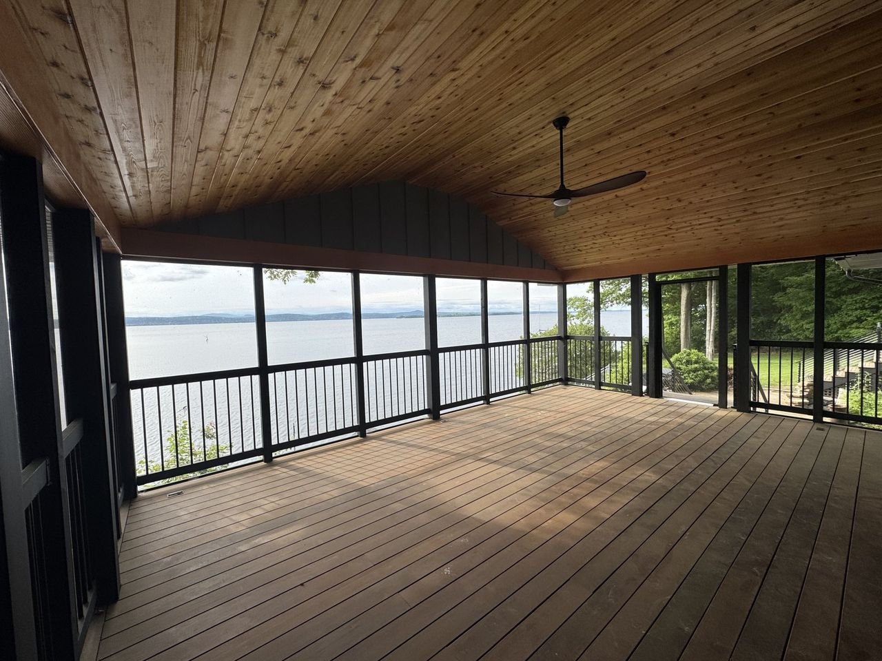 Screened porch with cedar ceiling and wide lake outlook